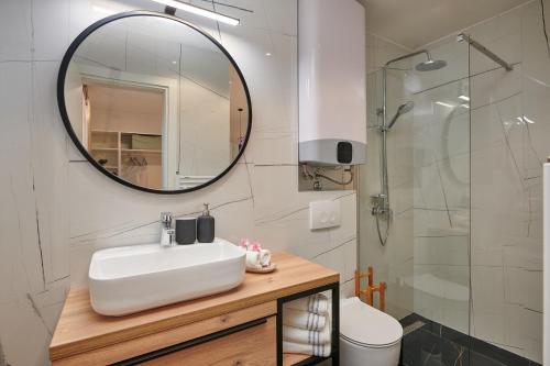 a bathroom with a sink and a mirror at Villa Nika with private heated pool in Slano