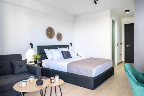 a bedroom with a bed and a couch at Nerea Boutique Suites Karystos in Karistos