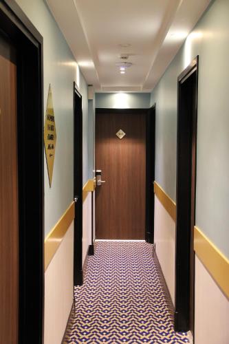 a corridor with a door at Hotel Le Rocroy in Paris