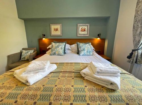 a bedroom with a bed with towels on it at The Ship in Parkgate