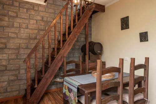 a wooden staircase in a room with a table at Casa de Campo Arco de São Jorge by An Island Apart in Santana