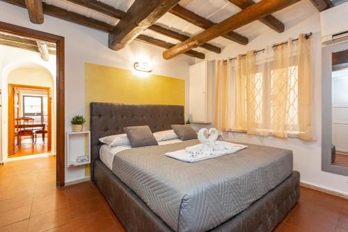a bedroom with a large bed with a tray on it at Ciambella Art Home-Rental in Rome in Rome