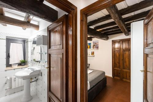 a bathroom with a sink and a bed in a room at Ciambella Art Home-Rental in Rome in Rome