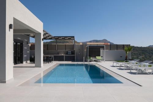 a swimming pool on the roof of a house at Eolides Villas , Quite Idyll of Rural Bliss,By ThinkVilla in Lambiní