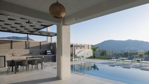 une maison dotée d'une piscine avec une table et des chaises dans l'établissement Eolides Villas , Quite Idyll of Rural Bliss,By ThinkVilla, à Lambiní