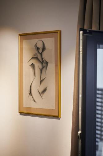 a drawing of a person hanging on a wall at Villa Nika with private heated pool in Slano