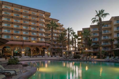 a swimming pool in front of a hotel at Suites at VDP Cabo San Lucas Beach Resort and Spa in Cabo San Lucas