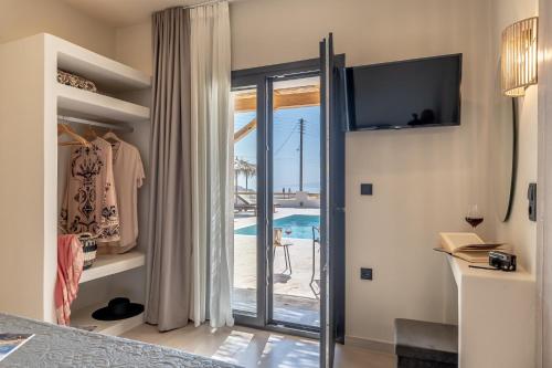 a bedroom with a sliding glass door to a pool at Golden Sand Villas with Private Pool in Vívlos