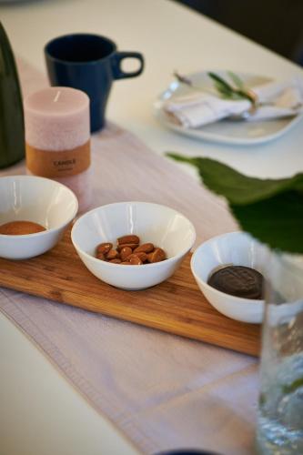 three bowls of nuts on a wooden cutting board at Villa Nika with private heated pool in Slano
