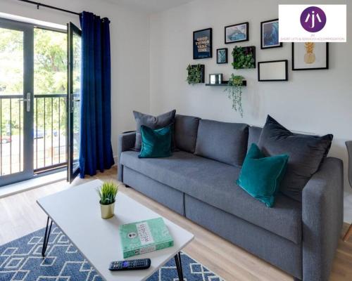 a living room with a couch and a table at Stevenage Luxury 1Bed Apartment - Sleeps 4-WIFI-Free Parking- By JM Short Lets & Serviced Accommodation in Stevenage