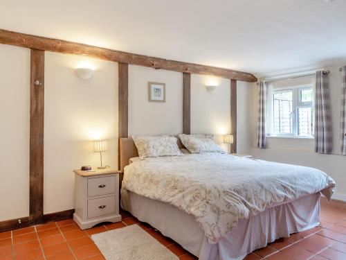 a bedroom with a large bed and a window at The Nest Box in Diss