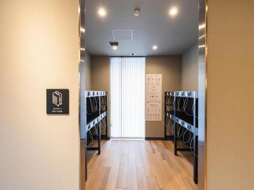 a dressing room with a hallway with a basketball court at Sotetsu Fresa Inn Sendai in Sendai
