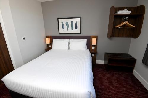 a bedroom with a large white bed in a room at Pine Marten, Dunbar by Marston's Inns in Dunbar