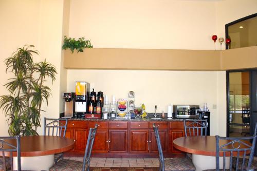 a restaurant with two tables and a counter with a bar at Days Inn by Wyndham Globe in Globe
