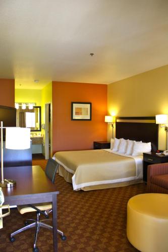 a hotel room with a large bed and a desk at Days Inn by Wyndham Globe in Globe
