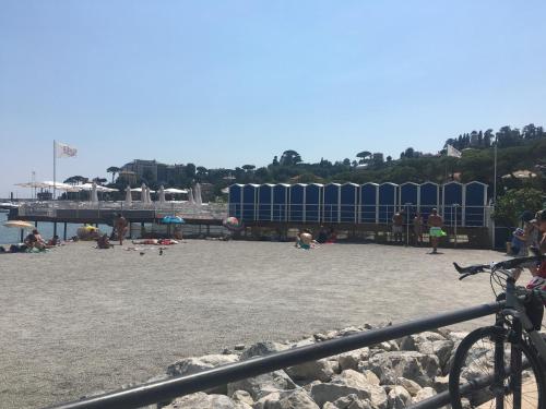 a group of people on a beach with a train at IN CENTRO A RAPALLO in Rapallo