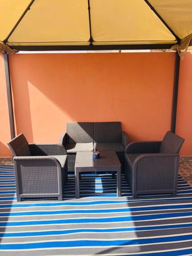 a group of chairs and a table in a tent at HOUSE l impérial pour vacance in Aourir