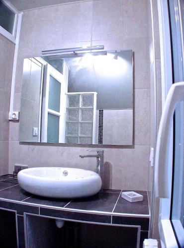 a bathroom with a sink and a large mirror at Villa Eth Mayouret in Cauterets