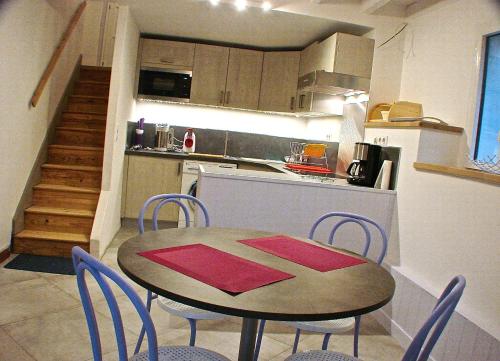 a kitchen with a table and chairs in a kitchen at Villa Eth Mayouret in Cauterets