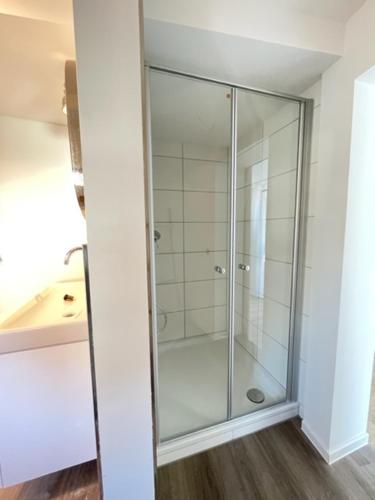a bathroom with a glass shower in a room at Hotel Jägerhof in Coesfeld