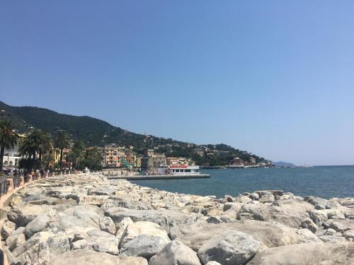 a group of people standing on a rocky beach at IN CENTRO A RAPALLO in Rapallo