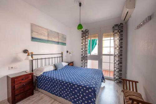 a bedroom with a blue bed and a window at Apart Luminoso céntrico 3 hab 2 baños in Seville
