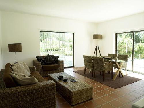 a living room with a couch and chairs and a table at Quinta Do Miguel in Aldeia do Meco