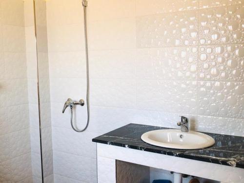 a bathroom with a sink and a shower at HOUSE l impérial pour vacance in Aourir