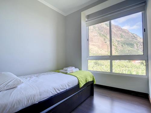 a bedroom with a bed and a large window at Sunny Side by Atlantic Holiday in Madalena do Mar