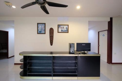 a room with a desk with a ceiling fan at Phi Phi Blue Lagoon in Phi Phi Don