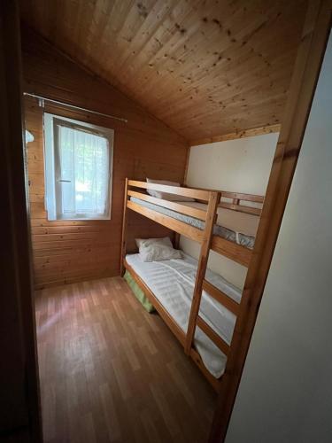 a small room with two bunk beds in it at Chalet agréable en bord en de mer. in Le Port-des-Barques