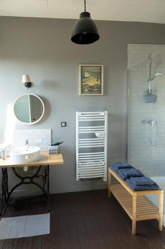 a bathroom with a sink and a toilet and a shower at La maison au fil du temps in Pont-Rémy