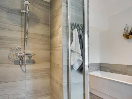 a bathroom with a shower with a glass door at The Cottage on Fairbank - Kirkby Lonsdale in Kirkby Lonsdale