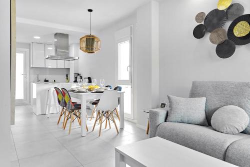 a white living room with a table and chairs at Apartment Golden Luna in San Pedro del Pinatar