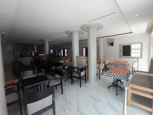a dining room with tables and chairs in a room at HOTEL CASTIYA in M'diq