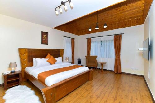 a bedroom with a bed and a desk and a window at The Premier Suites in Nairobi