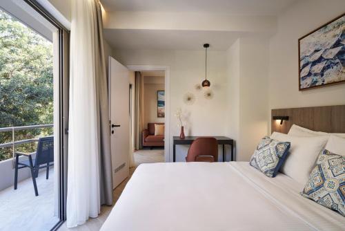 a bedroom with a large bed and a balcony at Hestia - Asklipiou 61 in Athens