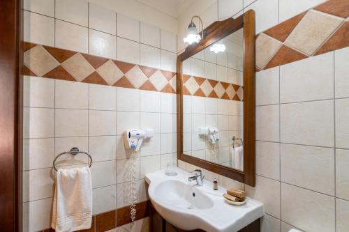 a bathroom with a sink and a mirror at Casa del Sole Boutique Hotel Timisoara in Timişoara