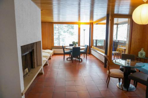 een woonkamer met een open haard en een tafel en stoelen bij Grosse 4 Zimmer Wohnung mit traumhafter Aussicht in Bad Ragaz