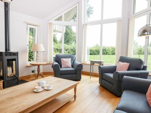 a living room with two chairs and a coffee table at Swandown, 12 Kittwhistle in Chard