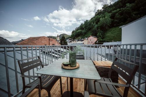 a table and chairs on a balcony with a view at the salt residences in Hallein