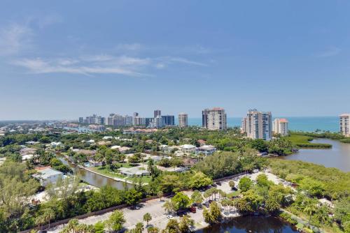 an aerial view of a city with a river and buildings at Naples Grande Beach Resort in Naples