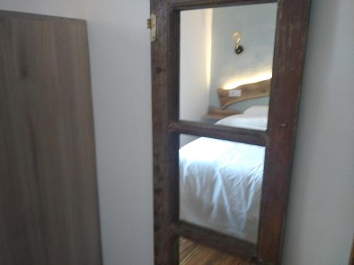 a mirror with a reflection of a bed in a room at Vivienda A Travesía Dos Soños in Sarria