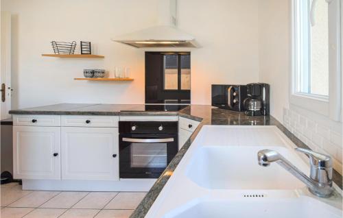 a kitchen with a sink and a counter top at Cozy Home In Sainte-mre-glise With Wifi in Sainte-Mère-Église