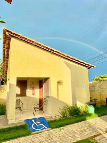 a small house with a blue rug in front of it at Pousada e Chalés Recantos do Mar in Barra Grande