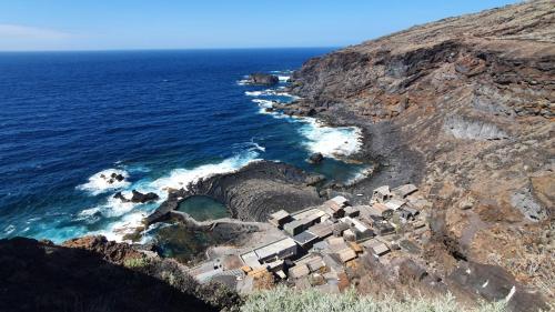 a group of cabanas on a cliff near the ocean at 7 Calcosas in Valverde