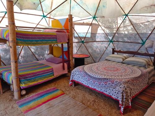 a bedroom with two bunk beds in a igloo at La Pacha Hostel in Barichara