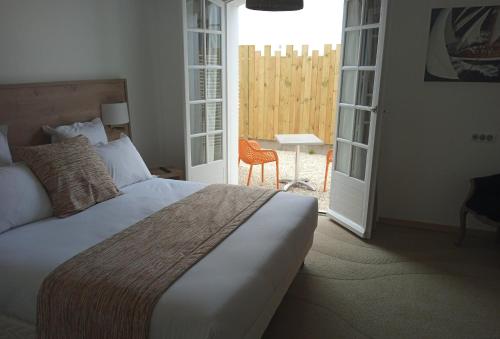 Cama o camas de una habitación en Hôtel Le Gois