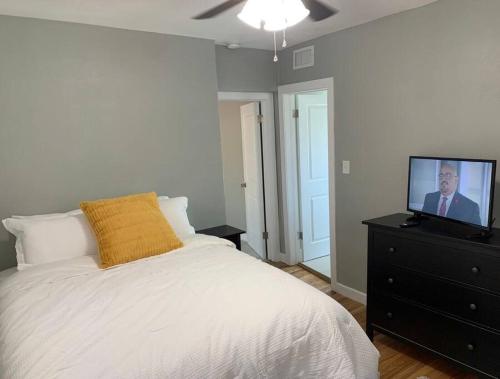 a bedroom with a bed and a tv on a dresser at Comfortable Suite with private entrance & private bathroom in El Paso