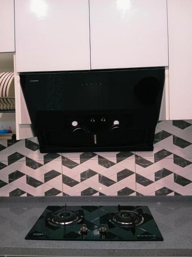 a black stove top in a kitchen with a tile floor at Preferred30 3R2B 7pax Meritus Perai in Perai